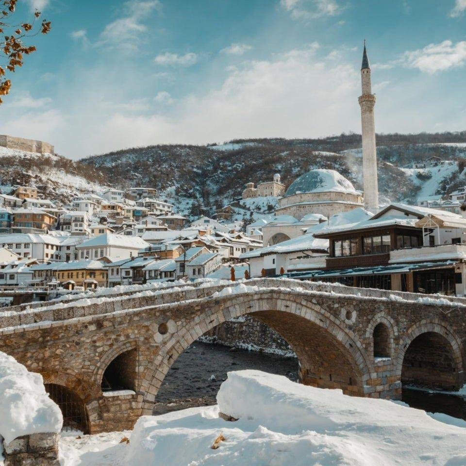 Prizren in winter with snow-covered rooftops, historic buildings and festive city scenery