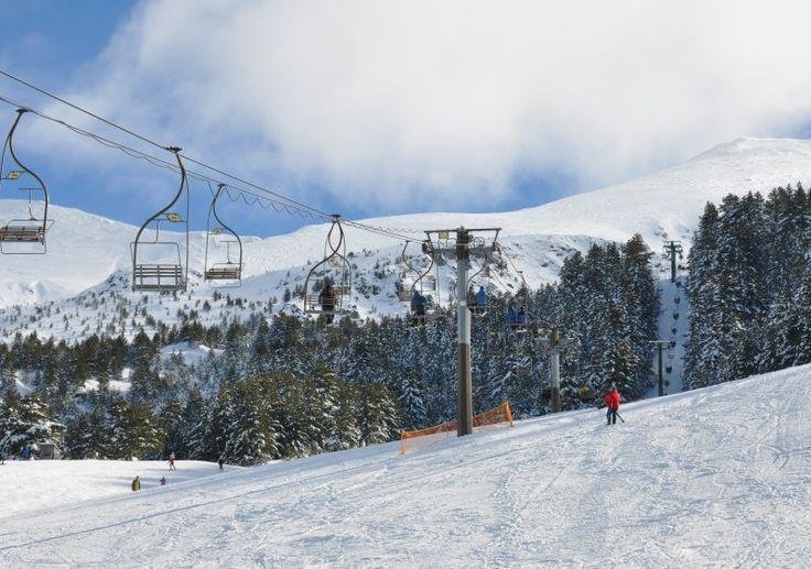 Brezovica ski resort in winter with snowy slopes, skiers and mountain scenery in Kosovo