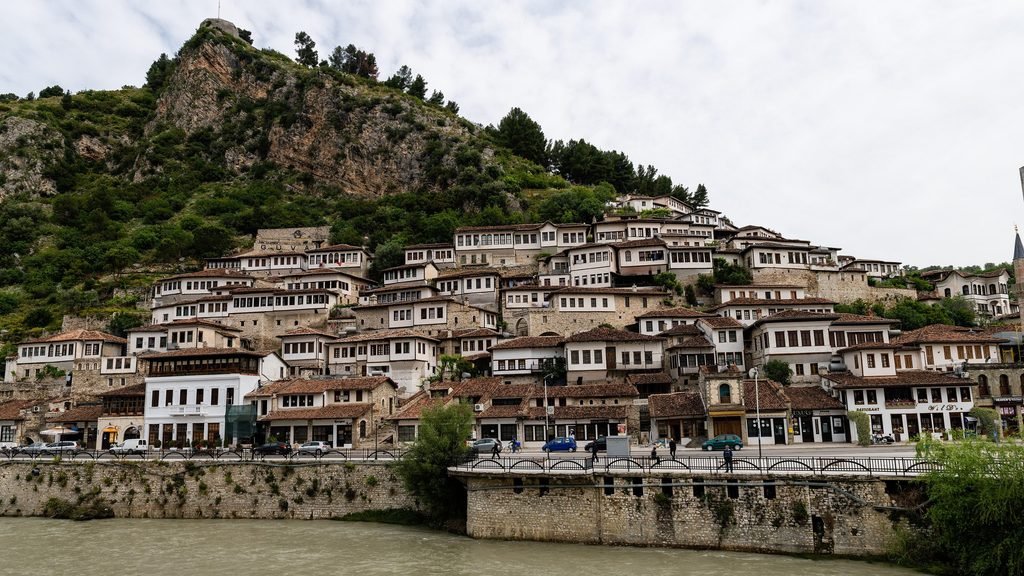 Panoramic view of the historic Mangalem neighborhood in Berat, Albania, featuring traditional hillside houses
