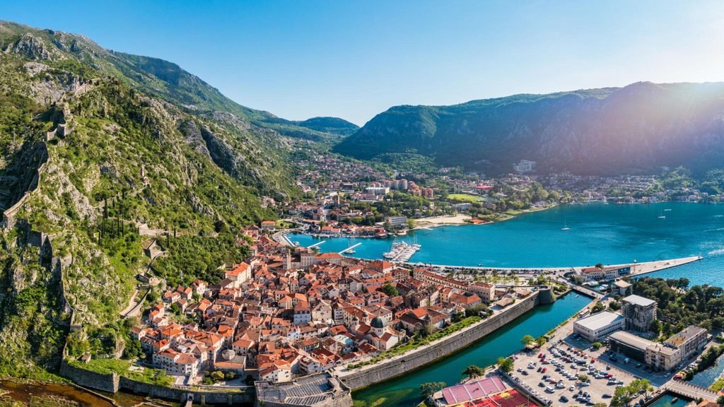 Panoramic view of the Bay of Kotor in Montenegro, surrounded by mountains and coastal settlements