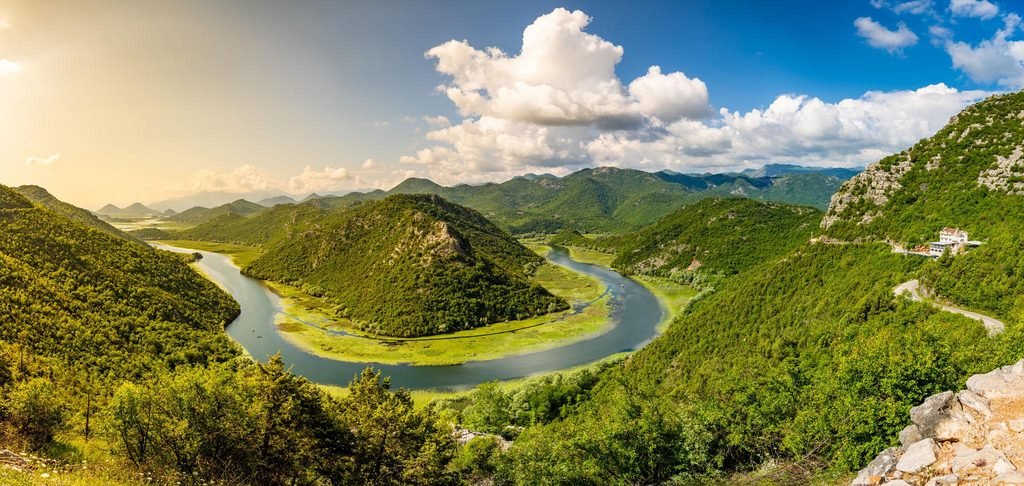 Panoramic view of Lake Skadar in Montenegro, surrounded by green hills and natural landscapes